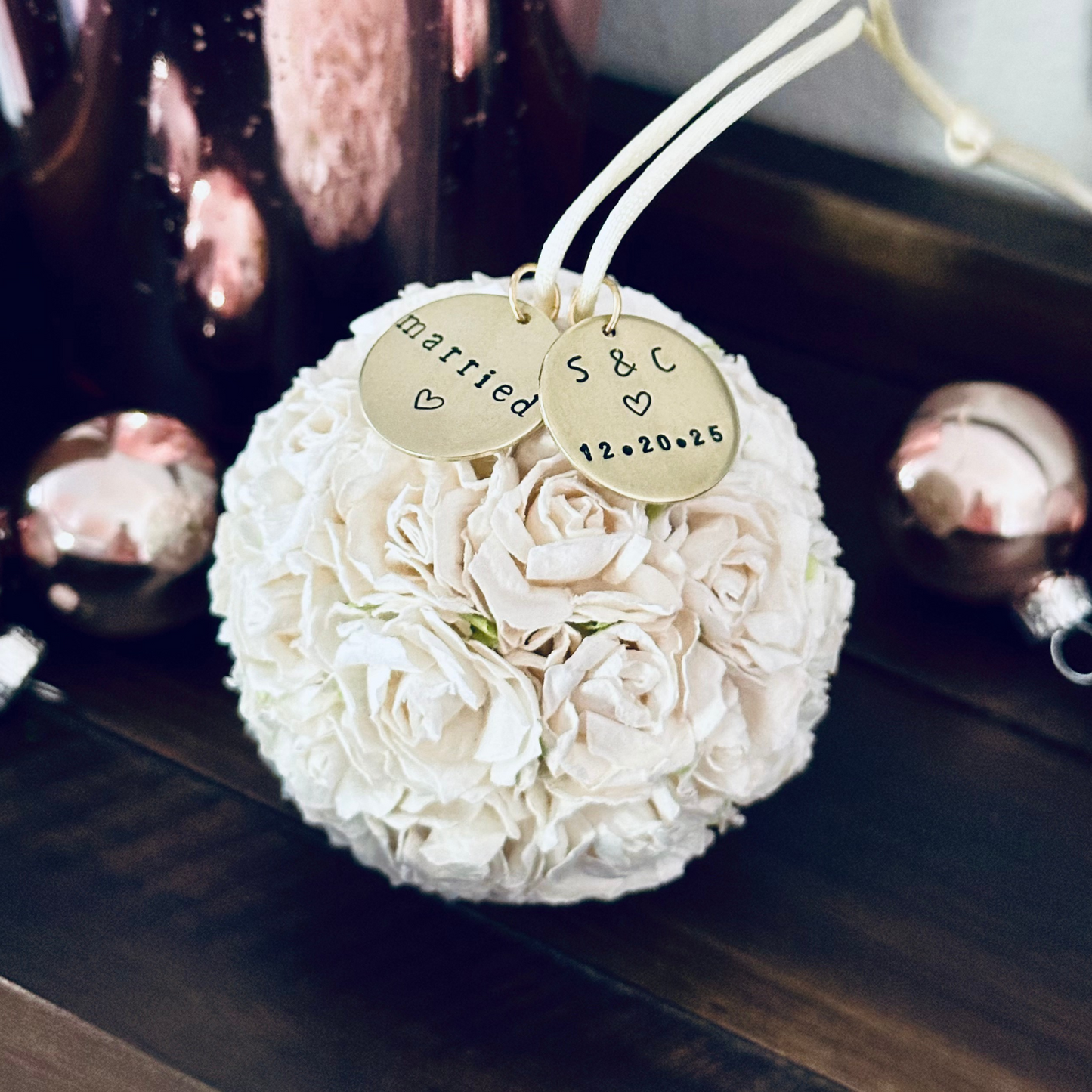 White rose flower ball Christmas ornament with personalized charms that read 'married', along with a couples' initials and wedding date.