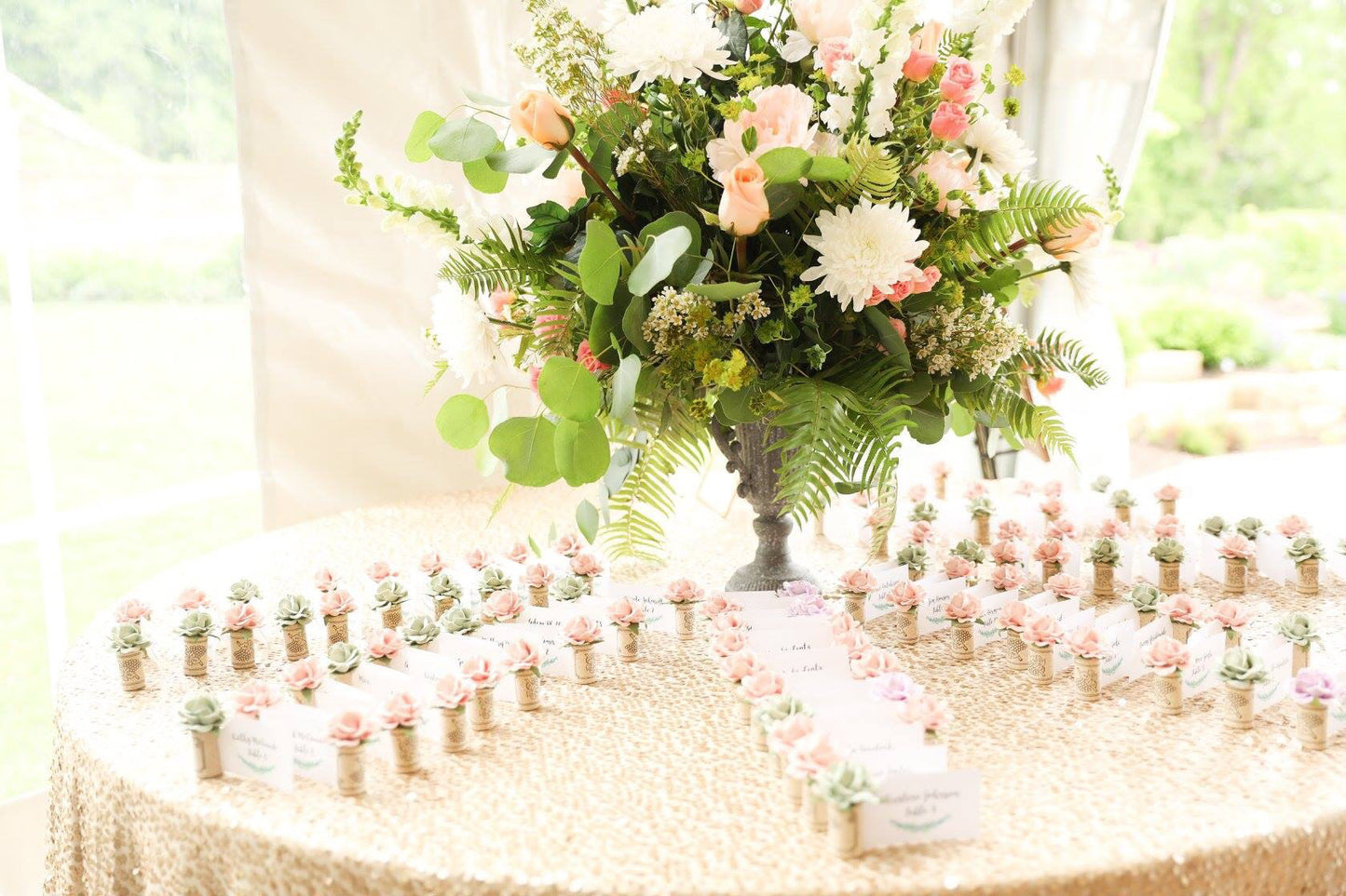 a beautiful wedding place card table with rows on cork place card holders and guest names with table assignments.