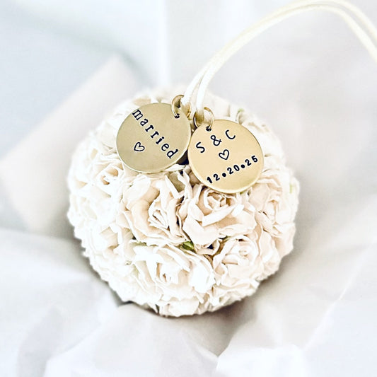 White wedding Christmas Ornament with personalized gold charms reading "married" and a couples' initials and wedding date.  Suggests an elegant wedding keepsake gift.