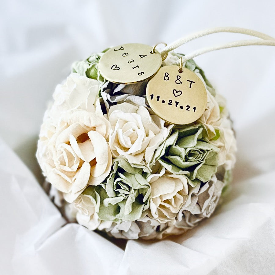 A flower theme ornament celebrating the 4 year wedding anniversary.  The flowers are in shades of white, sage, cream, and gray.