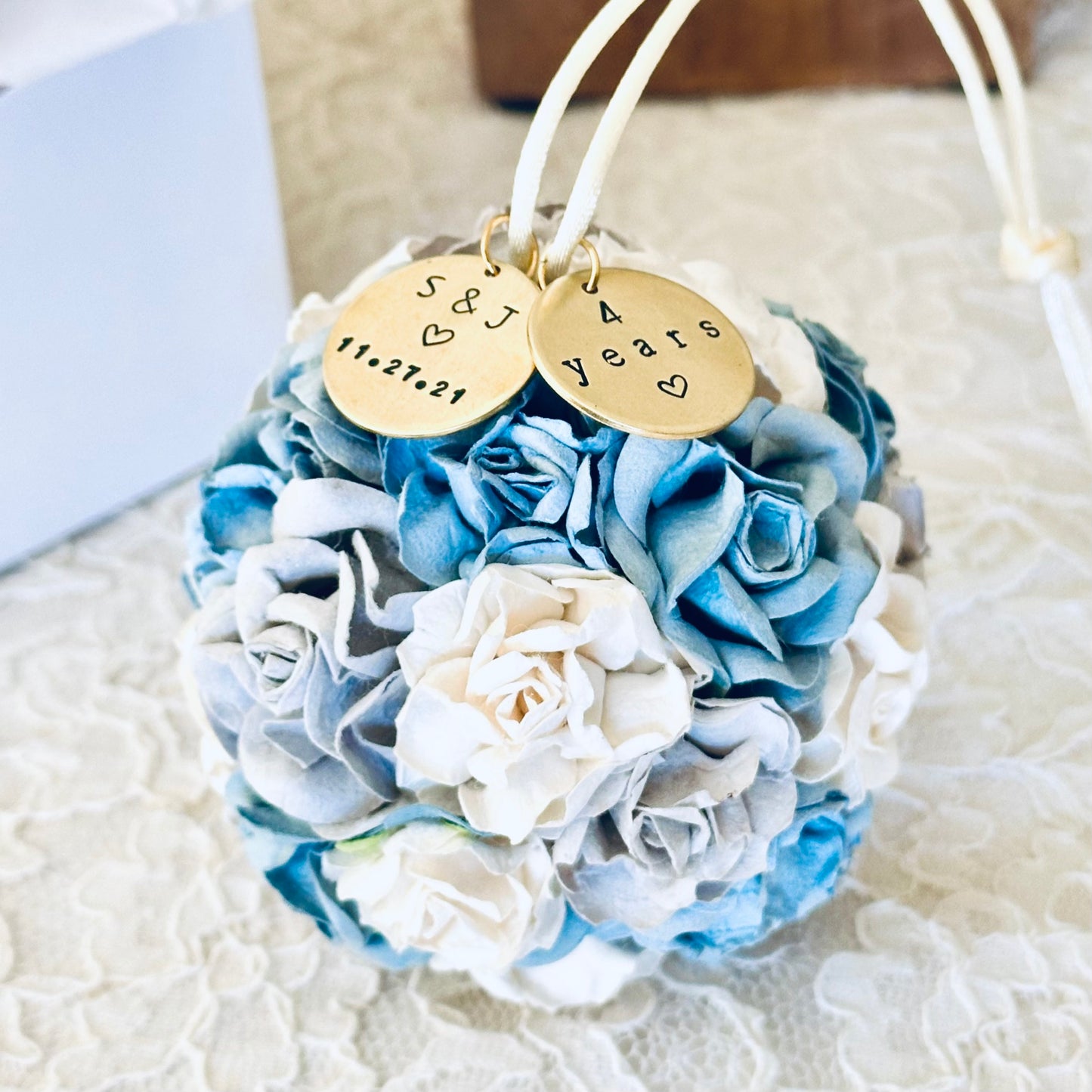 a 4 year wedding anniversary flower theme ornament in shades of dusty blue, cornflower, silver, and white.