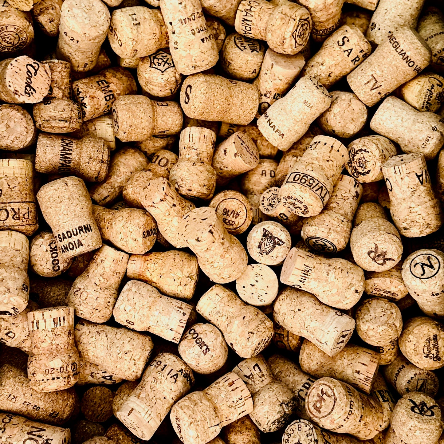 Collection of vintage champagne corks with various brand names.